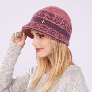 Detail of pink knit visor beanie for women with geometric patterns and butterfly metal accent