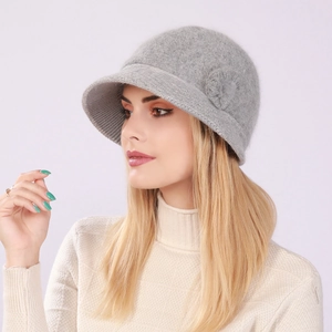 Detail of grey knitted cloche hat with floral accent and soft rabbit fur texture