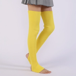 Detail of bright yellow ribbed knit leg warmers with stirrup heel for yoga and ballet