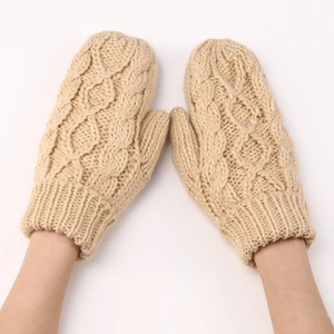 Detalle de mitones de punto beige con diseño de rombos y puños elásticos suaves