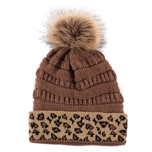 Detailed view of winter knit beanie featuring leopard print cuff and plush pom-pom