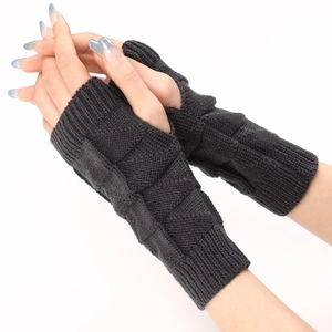 Close-up of dark grey cable knit fingerless gloves with thumb hole and ribbed texture