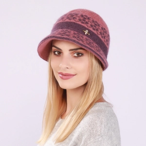 Close-up of knit winter hat detail with rhinestone butterfly charm and floral pattern