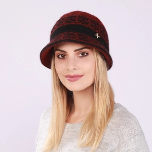 Detail of red and black knit beret with metallic insect buckle and decorative ribbon band