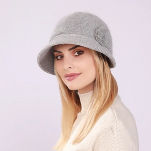 Detail of light gray knit cloche hat with a decorative flower and warm wool texture