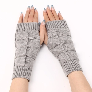 Macro shot of grey knitted fingerless gloves showing diamond textured knit and ribbed cuffs