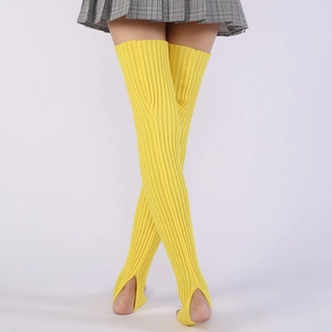 Detailed close-up of bright yellow stirrup leg warmers in ribbed knit for ballet and yoga