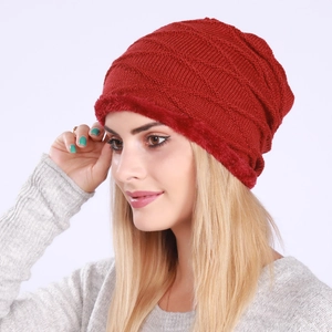 Red knit beanie with fleece lining and wavy pattern shown on a model for winter warmth