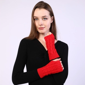 Close-up of red cable knit fingerless gloves showing thick texture and wrist coverage