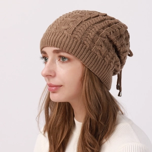 Detail of cable-knit texture and rear drawstring on a warm winter beanie hat
