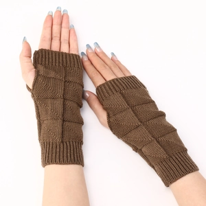 Detail of brown knitted fingerless gloves with a distinct chunky square texture