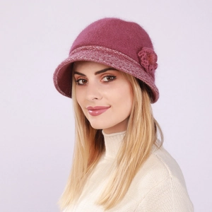 Detail view of pink knit bucket hat with rabbit fur texture and floral accent