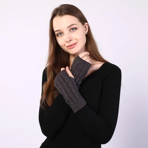 Detail of dark grey cable knit fingerless gloves showing texture and wrist fit