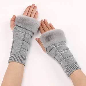 Detail of grey knitted fingerless gloves with soft faux fur cuffs and textured patterns