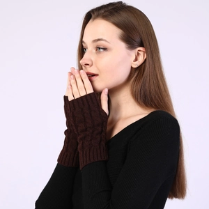 Detailed close-up of dark brown cable knit fingerless gloves for autumn and winter