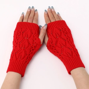 Macro detail of red knitted fingerless gloves with hollow leaf pattern and ribbed cuff