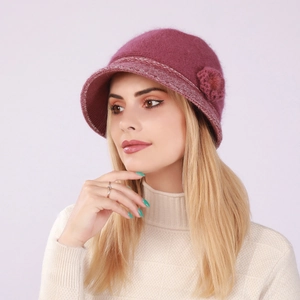 Detail of dark purple knitted bucket hat featuring a floral ornament and warm fleece lining