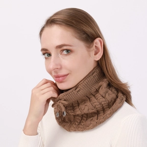 Macro detail of brown cable-knit scarf with adjustable drawstring and metal tips