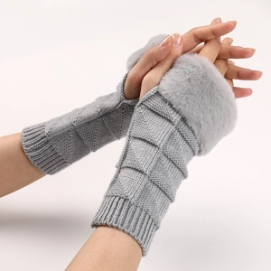 Close-up of grey knit fingerless gloves with fluffy faux fur cuffs and textured pattern