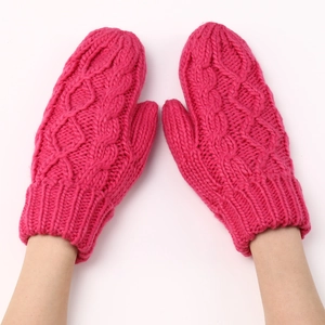 Detalle de mitones de punto de cable rojo rosa con puños elásticos de lana gruesa