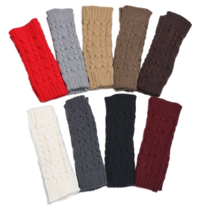 Macro detail of various cable knit arm warmers in nine different colors and textures