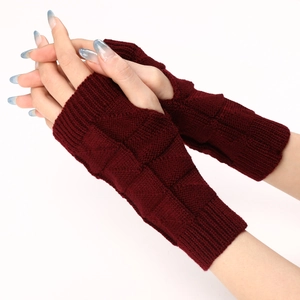 Close-up of dark red fingerless knit gloves with textured square pattern for winter