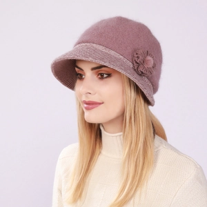 Detailed view of knitted flower ornament on warm pink rabbit fur winter bucket hat