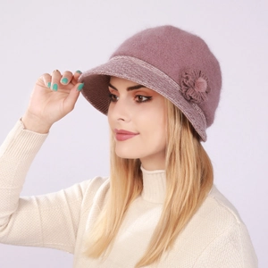 Detail of pink knitted cloche hat featuring a 3D floral accent and soft rabbit fur texture