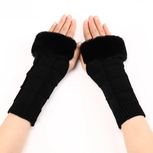 Close-up of black ribbed knit fingerless gloves with fluffy faux fur trim details