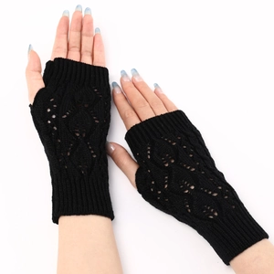 Detail of black knit fingerless gloves featuring hollow leaf pointelle patterns and ribbed cuffs