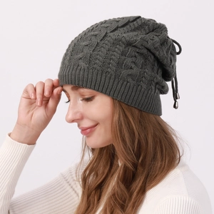 Detailed knit texture and drawstring with metal tips on charcoal gray cable beanie