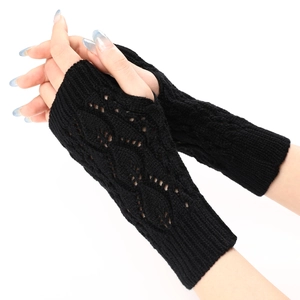 Close-up of black knitted fingerless gloves with elegant hollow leaf patterns and ribbed cuffs