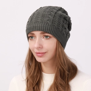 Detailed knit texture of dark grey cable beanie with soft fleece lining for winter warmth