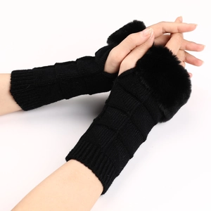 Close-up of black knitted fingerless gloves with faux fur trim and textured checkered pattern