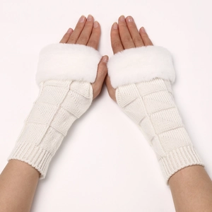 Macro shot of white chunky knit fingerless gloves with plush faux fur trim detail