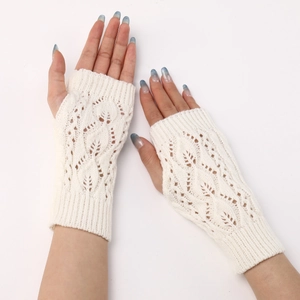 Detailed view of white knit fingerless gloves with elegant hollow leaf pattern textures