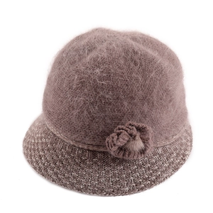 Detail of grey-pink knit bucket hat with soft plush faux fur and flower decoration
