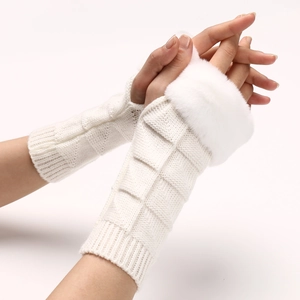 Close-up of white knitted fingerless gloves featuring soft faux fur trim and textured patterns