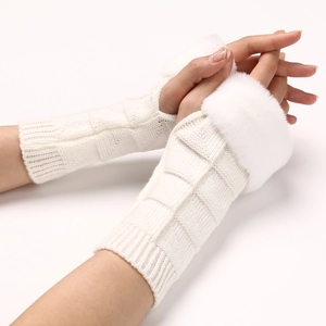 Detailed close-up of knitted fingerless gloves with soft white faux fur trim and thumb hole