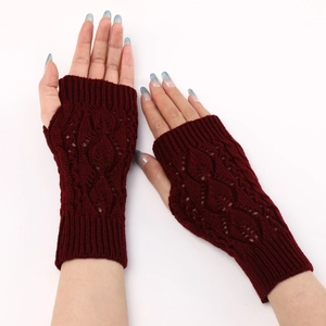 Detailed knit texture of burgundy fingerless gloves with openwork leaf patterns
