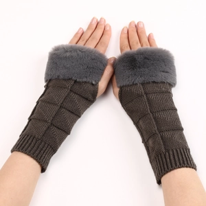 Detail showing knit waffle texture and dark grey faux fur trim on tan fingerless gloves