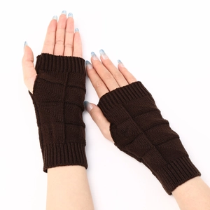 Close-up of dark brown knitted fingerless gloves showing the textured checkerboard pattern