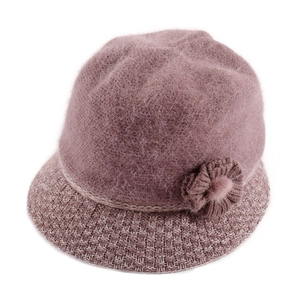 Close-up of pink knit bucket hat featuring rabbit fur texture and floral decoration