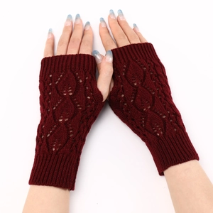 Detailed knit leaf hollow pattern and ribbed cuff on dark red fingerless gloves