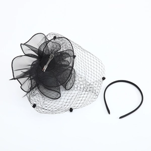 Detail of black fascinator hat with mesh veil, feathers, and matching headband set