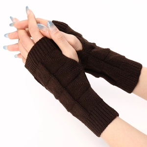 Close-up of dark brown knitted fingerless gloves with diamond textured pattern details