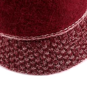 Macro detail of wine red felt knit hat showing thick texture and dual-color stitch design