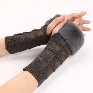 Detail of dark brown knitted fingerless gloves with grey faux fur trim and textured grid pattern
