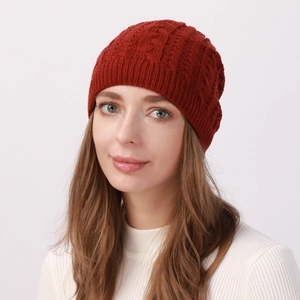 Close-up of cable knit texture on deep red beanie hat for winter warmth