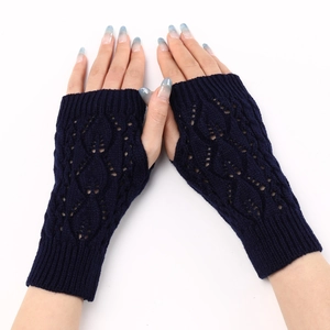 Detail of navy blue knit fingerless gloves featuring hollow leaf pattern and ribbed cuffs